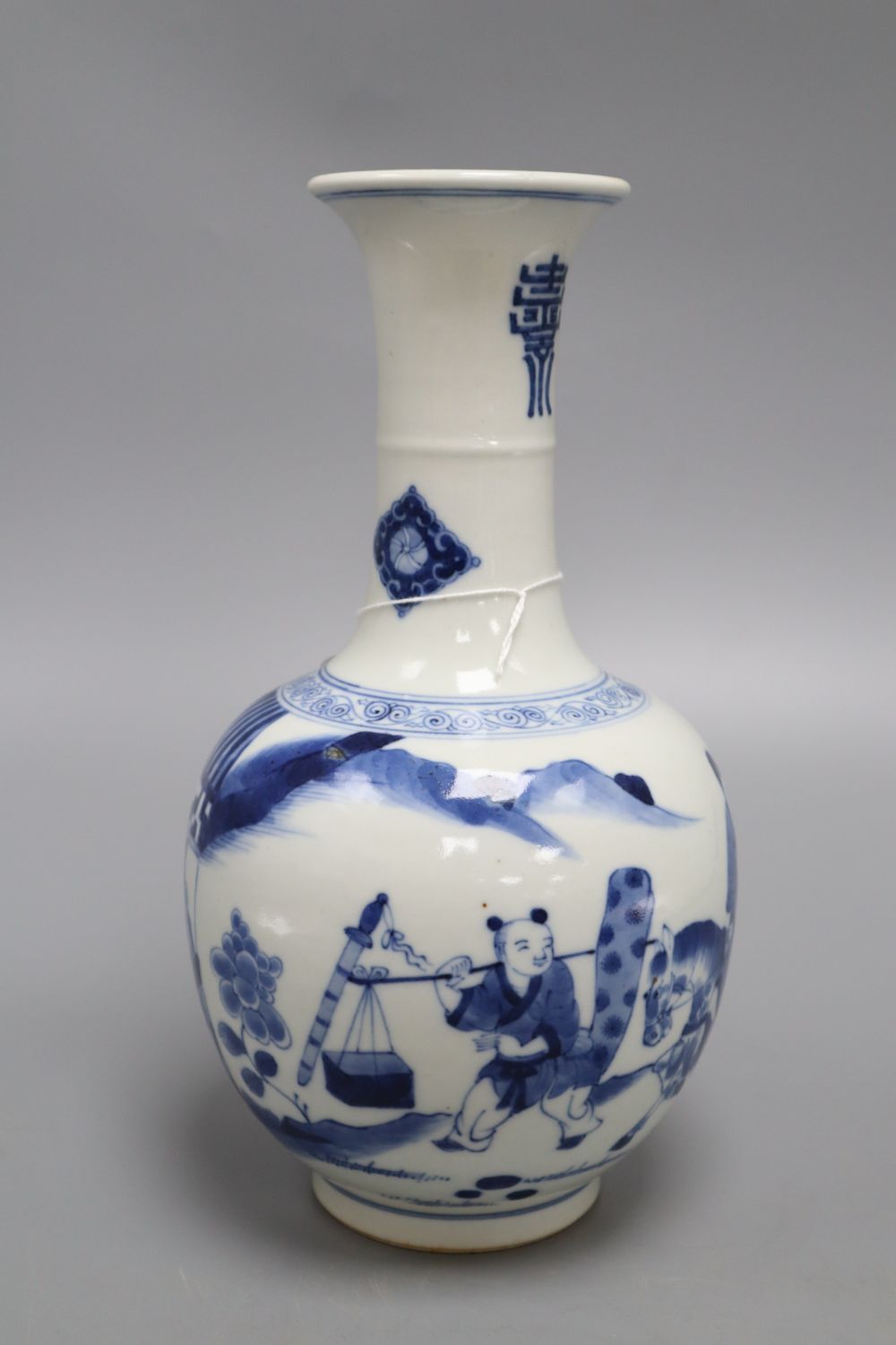 A Chinese blue and white figurative bottle vase, with four character mark to base, height 26cm